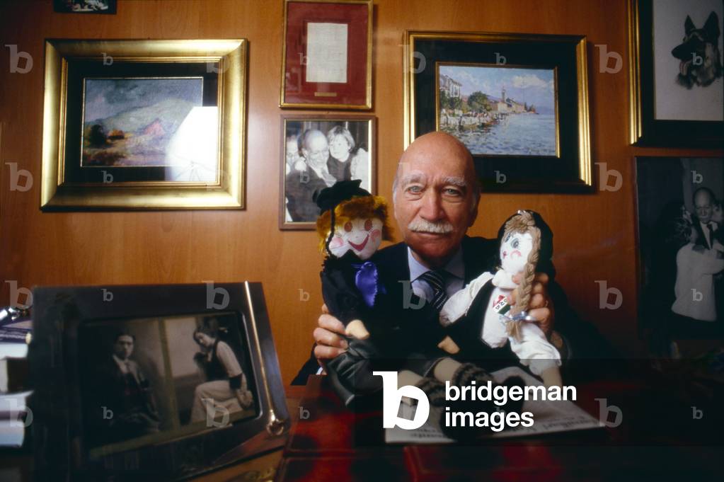 Giorgio Almirante holding two rag dolls