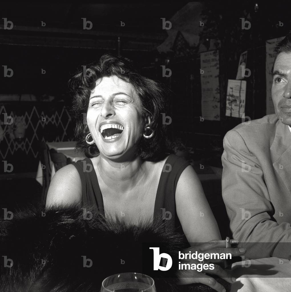 Anna Magnani laughs herself silly, 1956 (b/w photo)