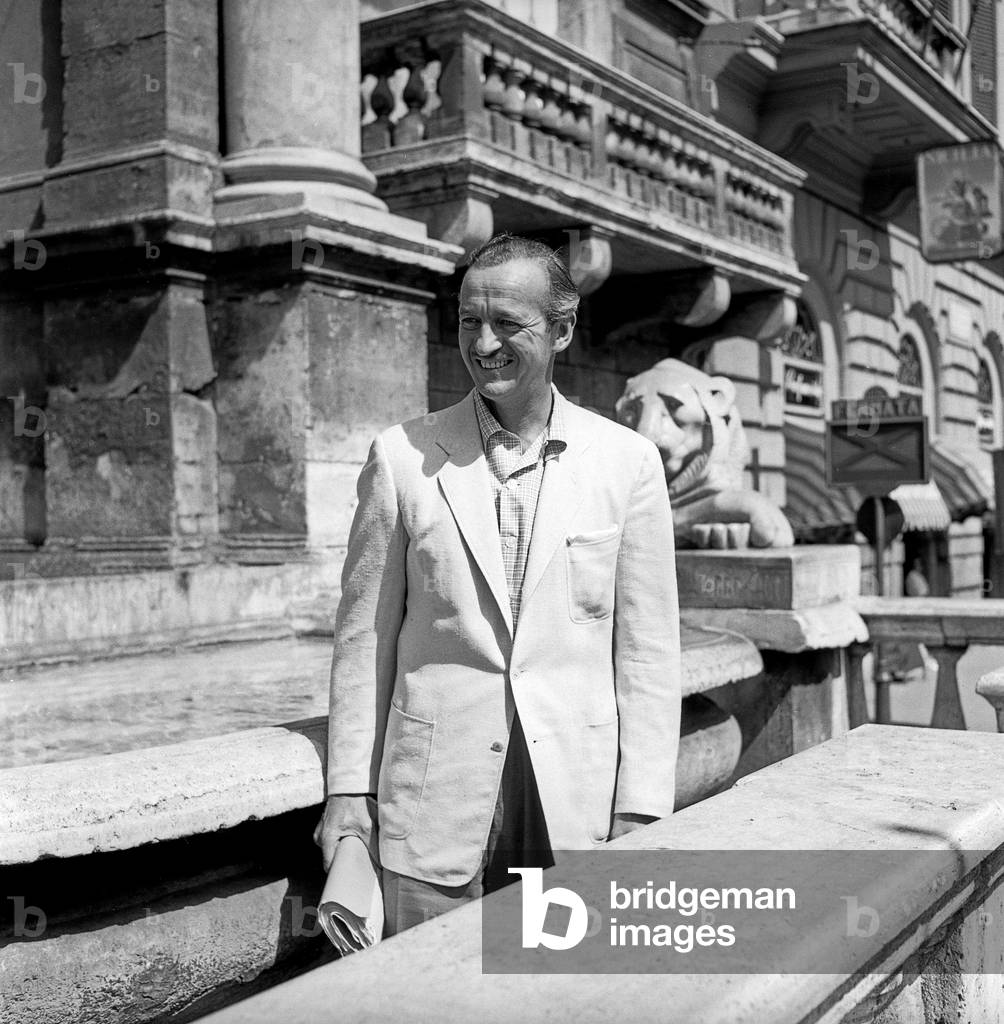 David Niven walking in Rome, Rome, Italy, 1956 (b/w photo)