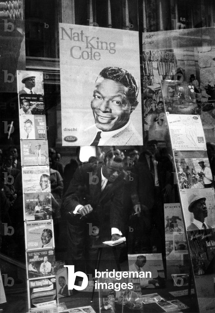 Nat King Cole looks out a shop window, Milan, Italy