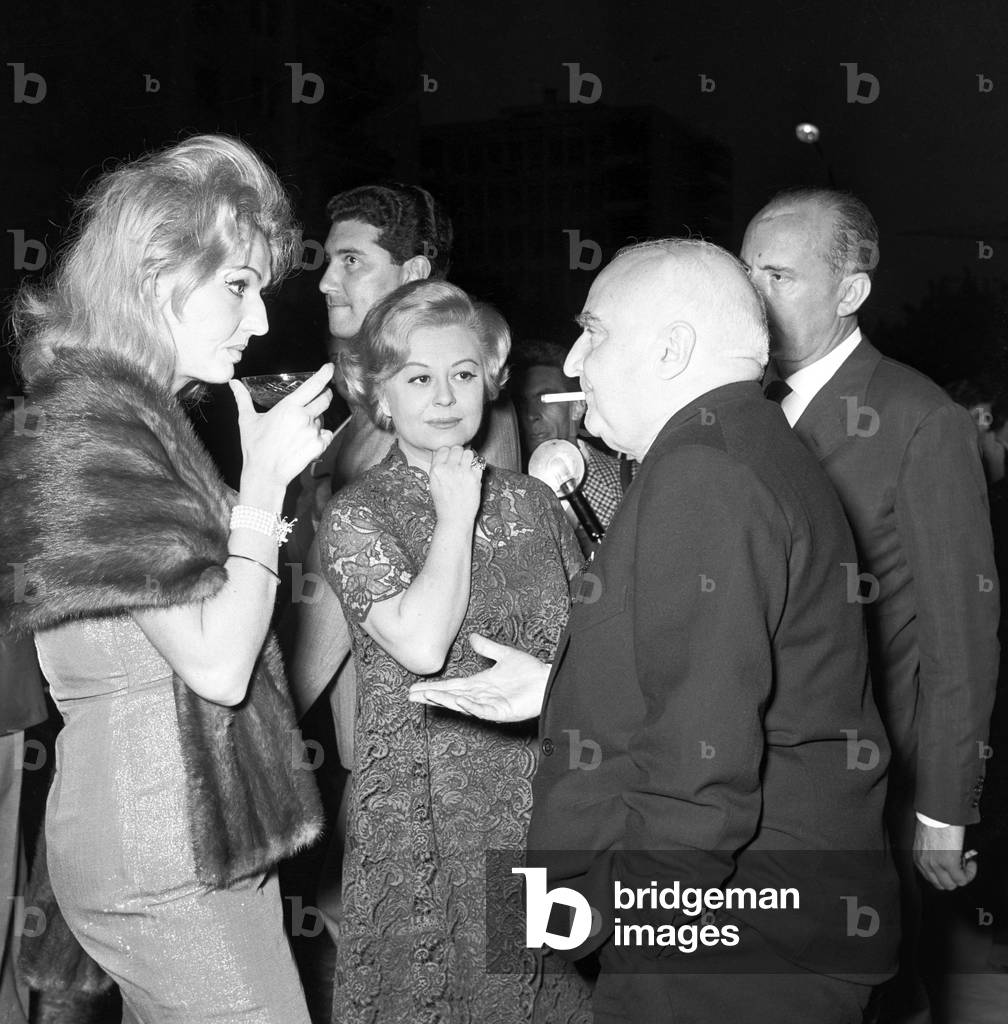 Giulietta Masina, Anna Salvatore and Angelo Rizzoli during a cocktail, Italy, 1957 (b/w photo)