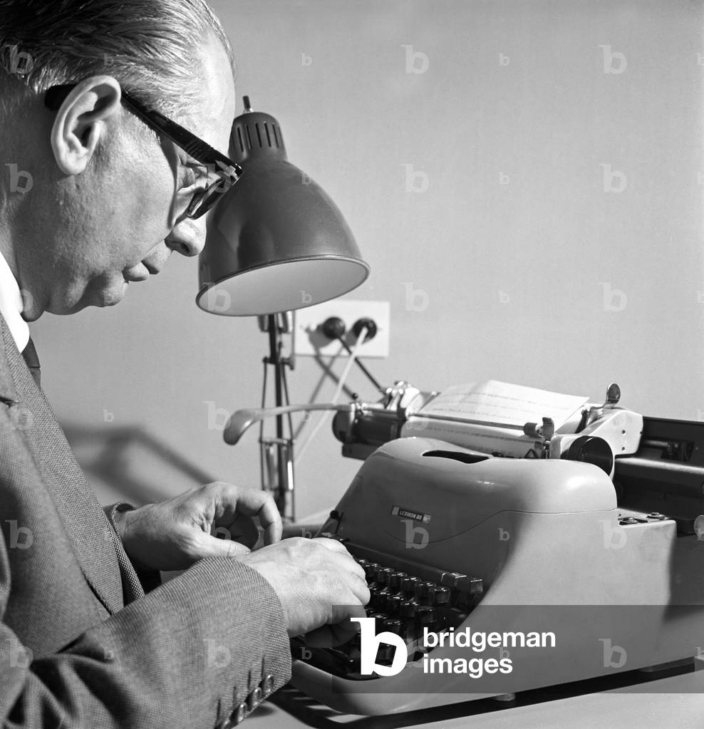 Enrico Mattei typewriting, Italy, 1961 (b/w photo)