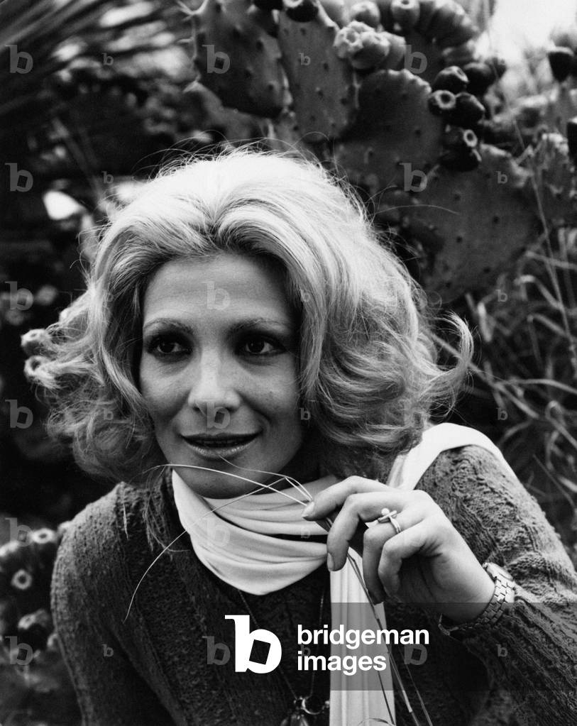 Mariolina Cannuli smiling with a grass thread in her fingers