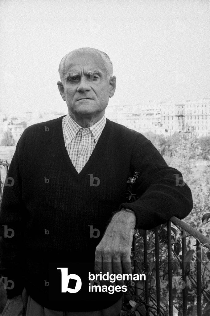 Alberto Moravia leaning on a rail, Italy, 1960