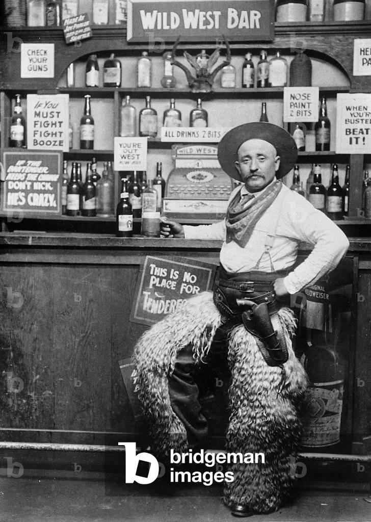 Man dressing up as a cowboy in a bar