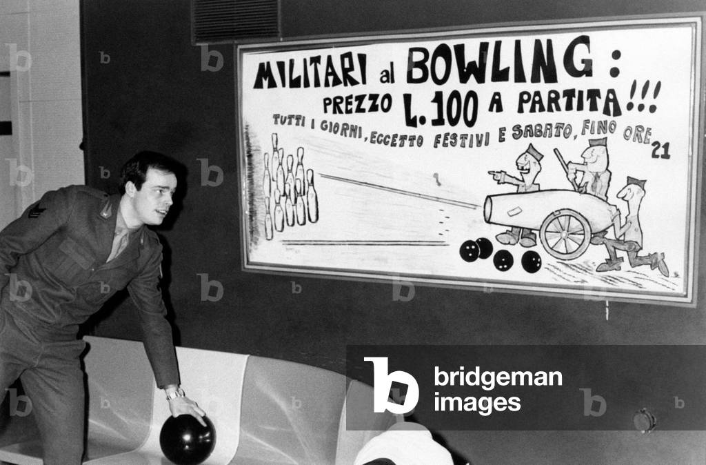 Dino looking at a sign in a bowling center
