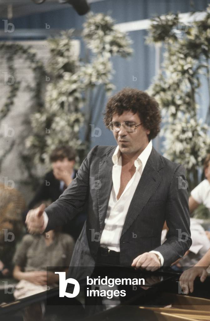 Peppino di Capri beside a piano