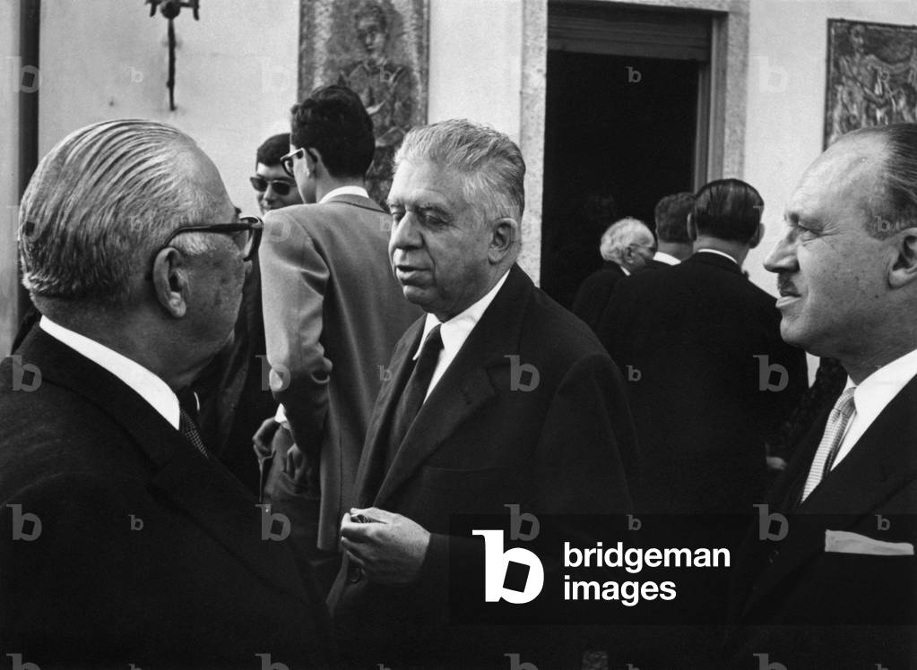 Italian publisher Arnoldo Mondadori celebrating his golden wedding with Italian poet Eugenio Montale and Italian writer Guido Piovene, Meina, October 1963 (b/w photo)