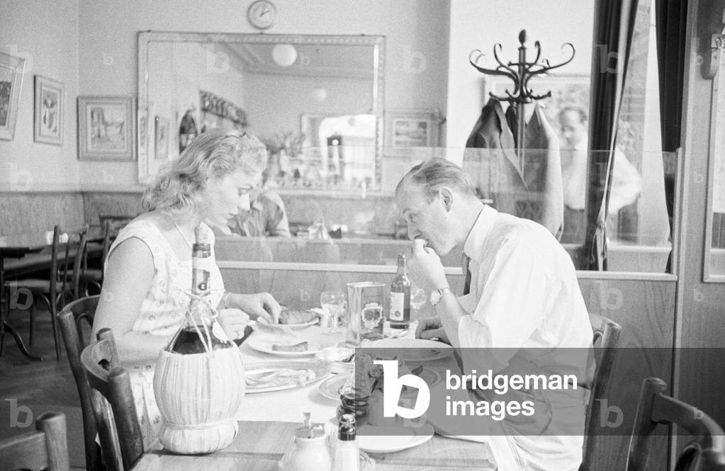 Roberto Carugati dining with his wife Paola at his restaurant in Geneva, Switzerland (b/w photo)