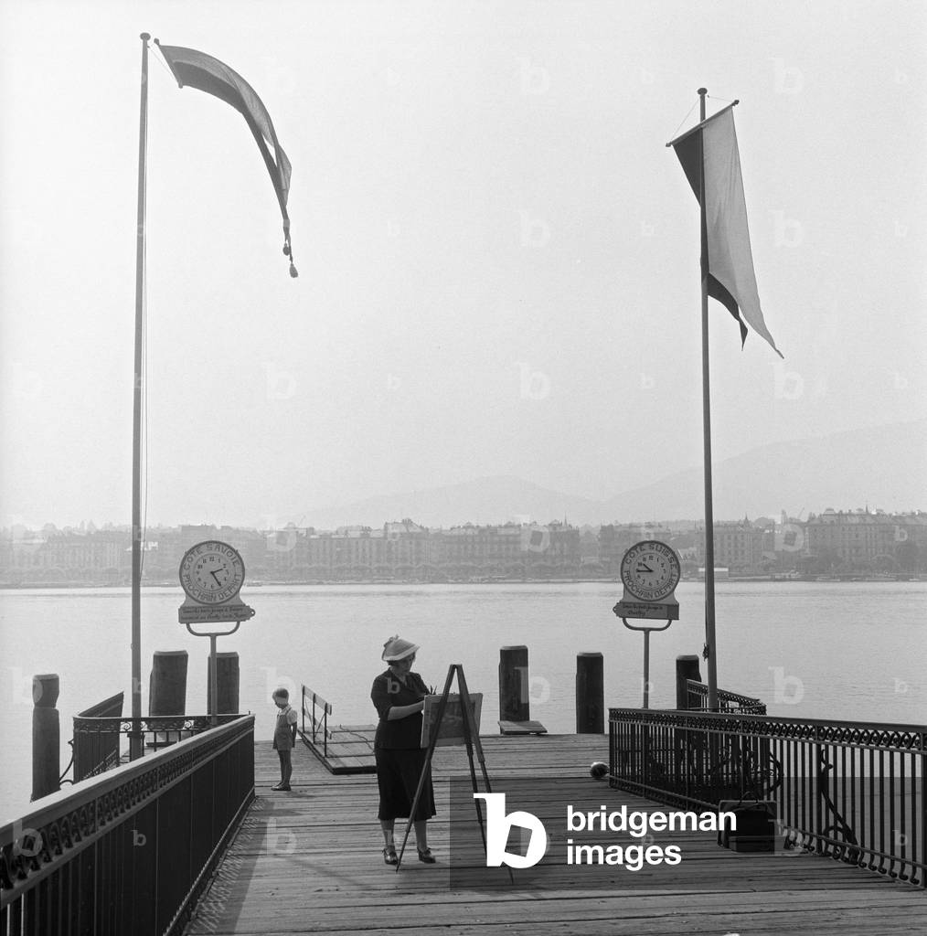 A woman painting on a dock by the Geneva Lake, Geneva, Switzerland