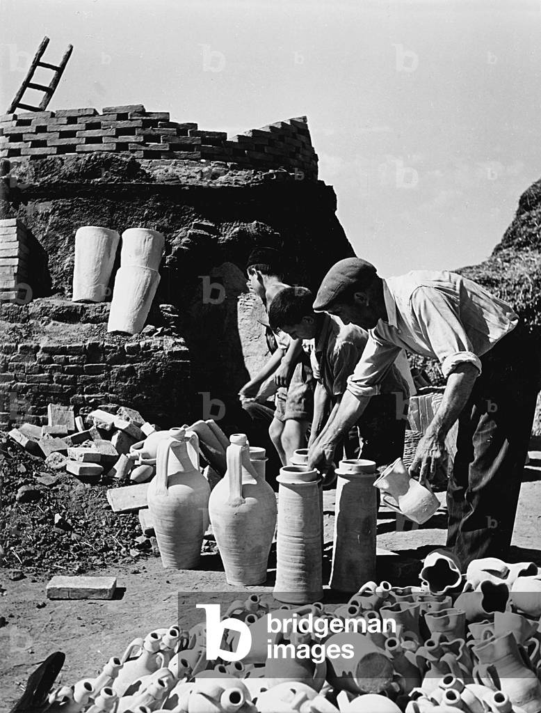 Sicilian potter at work, Italy, 1950 (b/w photo)