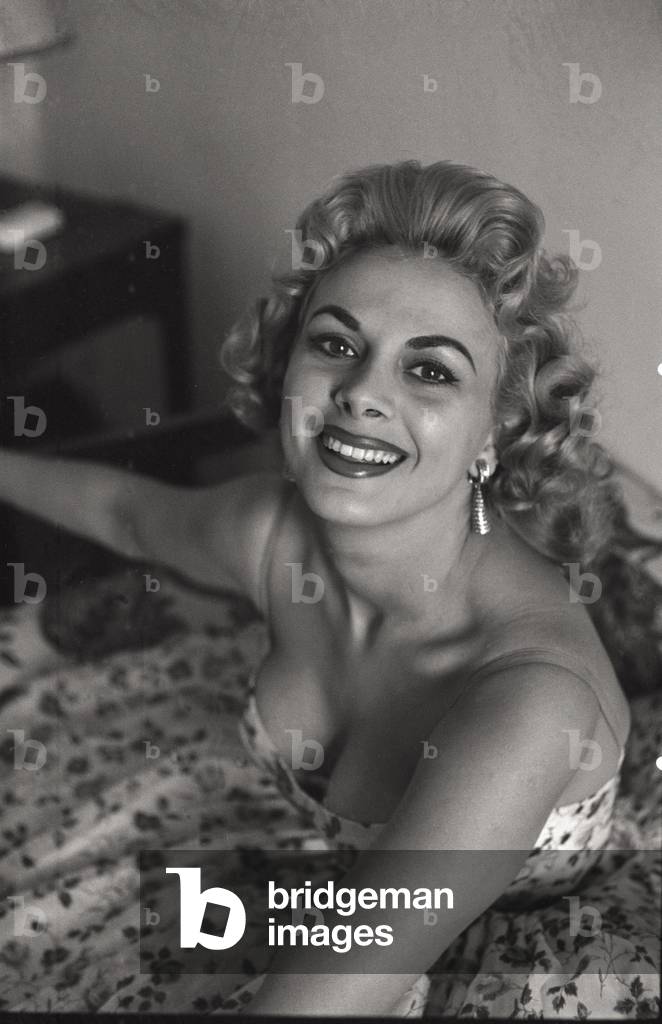 A photo of Sandra Milo in a floral dress seen from above