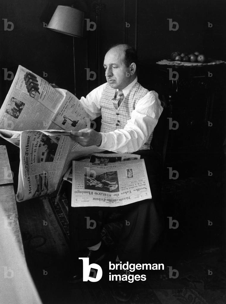 A man reading the Sunday Herald Tribune