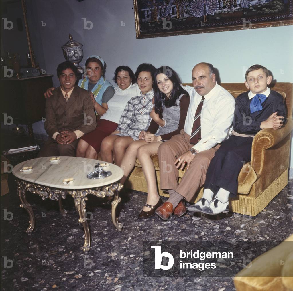Rosanna Fratello sitting on the sofa with her family, Italy