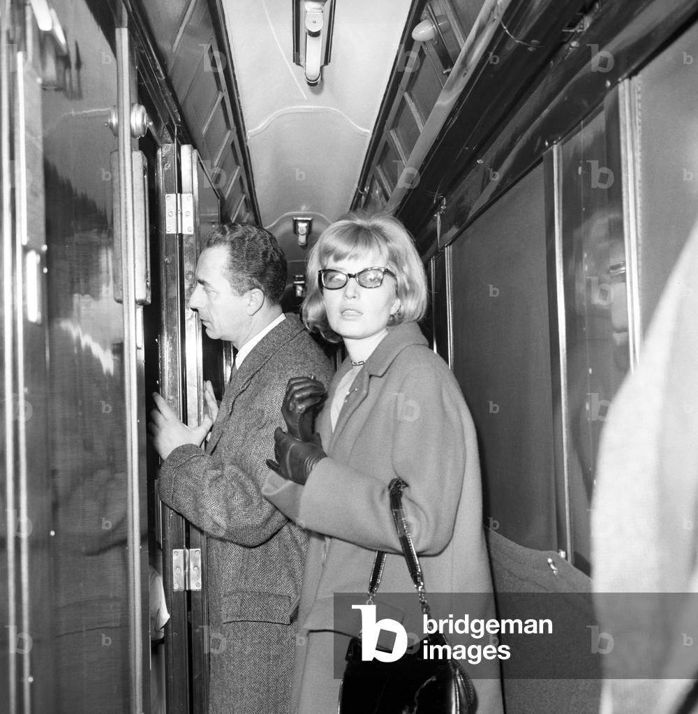 Monica Vitti and Michelangelo Antonioni leaving Rome, Italy, 1962 (b/w photo)