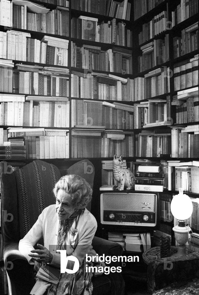Gianna Manzini sitting in an armchair in her study