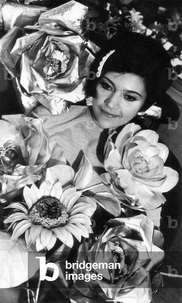 Close-up of a woman surrounded by paper flowers , Milan, Italy