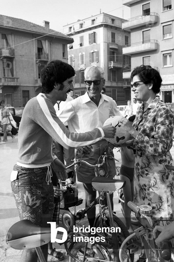 Luigi Meroni autographing a soccer ball
