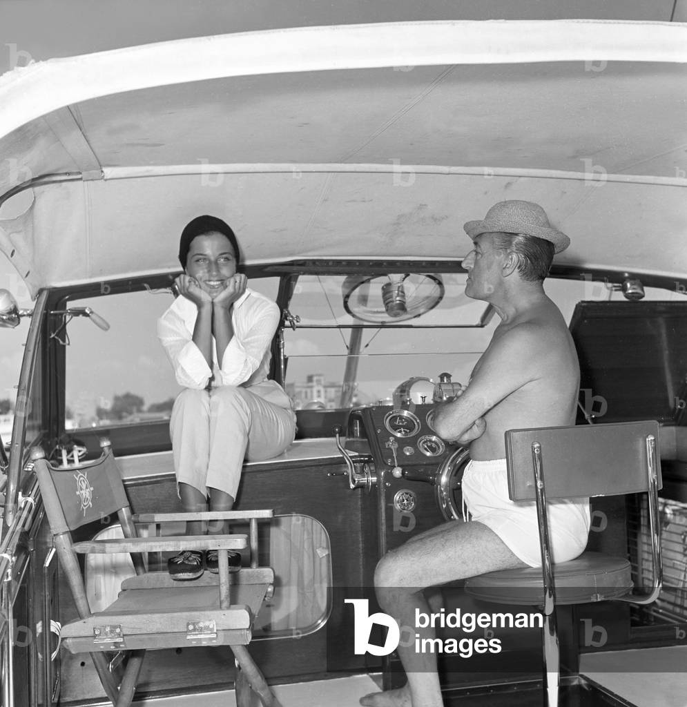 Totò and Franca Faldini in a boat, Italy, 1955 (b/w photo)