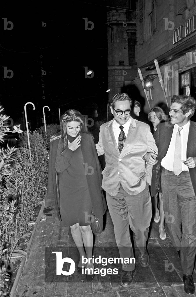 Anouk Aimée and Omar Sharif outside the restaurant 'Dal Bolognese', Rome, Italy, 1968 (b/w photo)