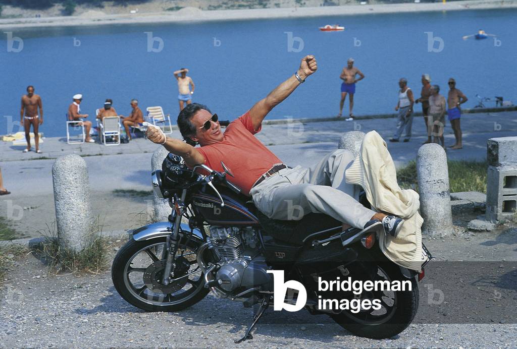 Enzo Jannacci lying on a motorbike, Sanremo, Italy