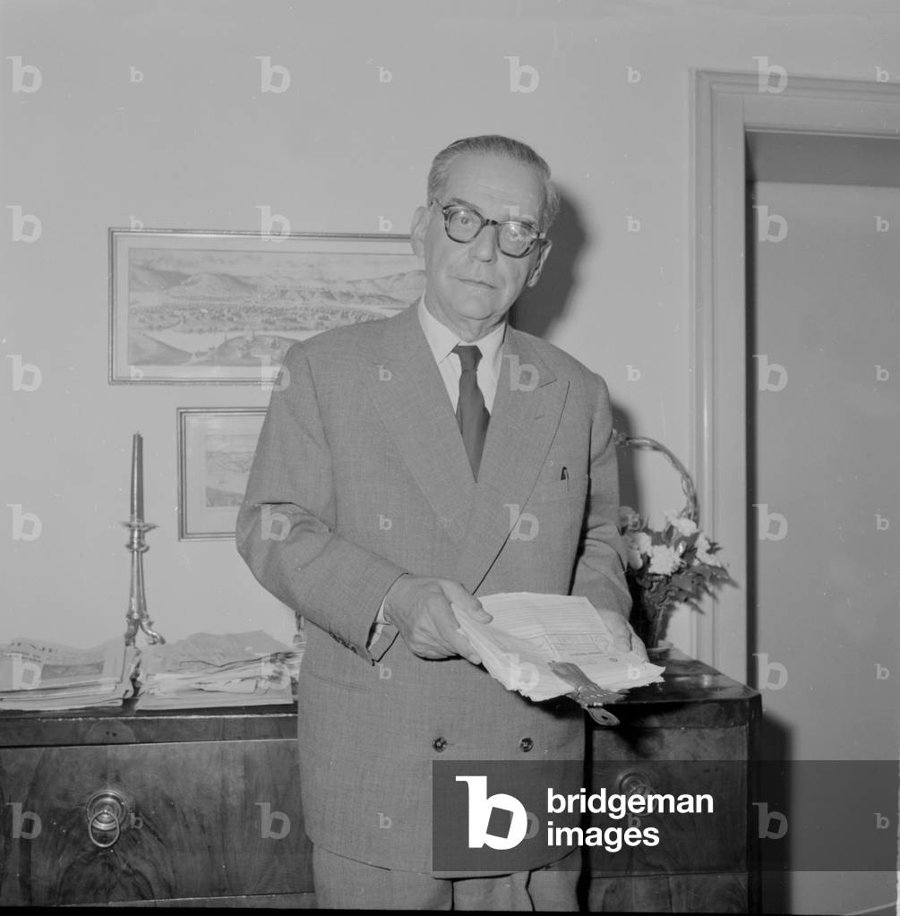 Ivo Andric holding some documents, 1960 (b/w photo)