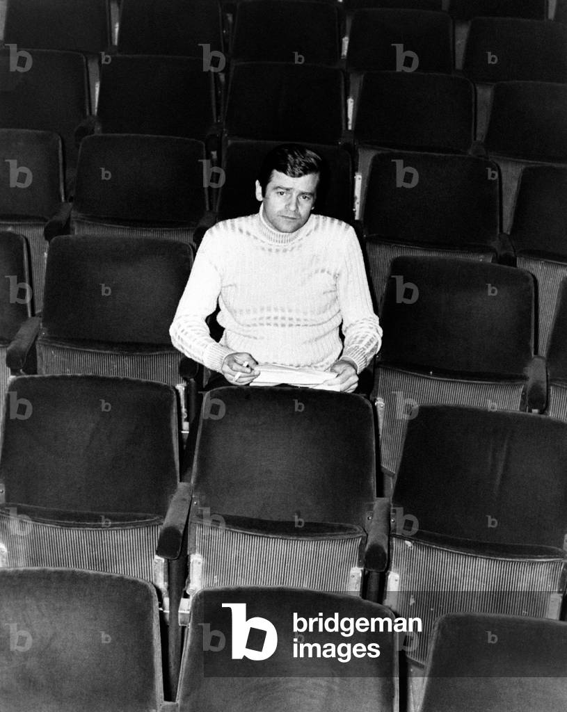 Sergio Endrigo seated on a seat of empty stalls