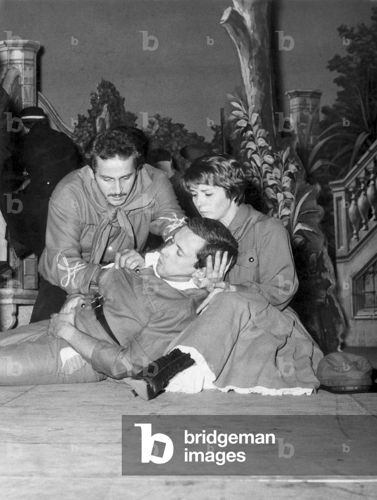 Domenico Modugno and Delia Scala take care of Paolo Panelli, lying down onstage with his eyes closed, Turin, Italy