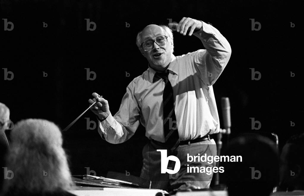 Slava Rostropovich conducting an orchestra with his arm raised, United States, 1984