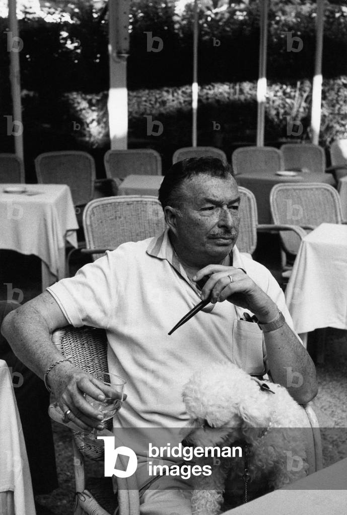 Xavier Cugat keeping a dog on his knees