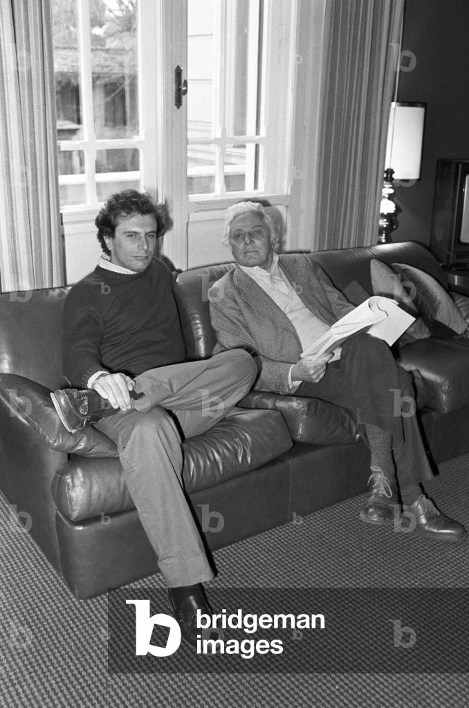 Dino Risi and his son Marco in their living room at home, Italy, 1983 (b/w photo)
