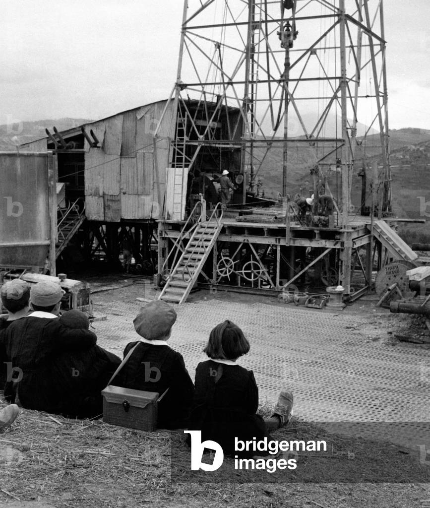 Children looking at the oil extraction, Italy