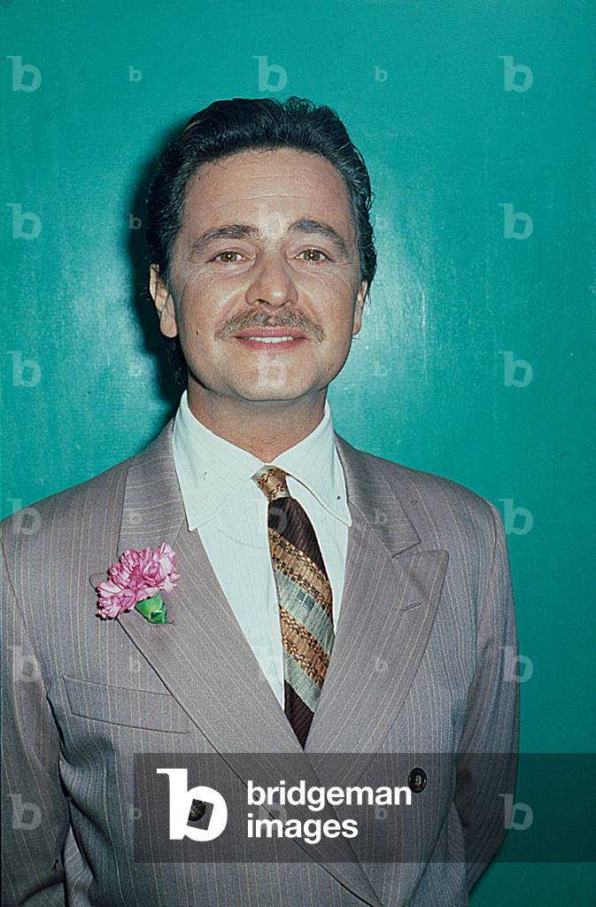 The comedian Beppe Grillo with no beard for the last night of 38th Sanremo Music Festival, Sanremo, Italy, 1988 (b/w photo)