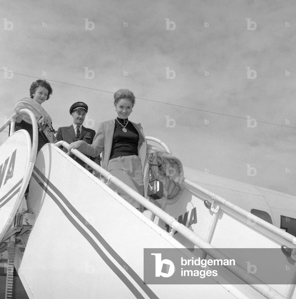 Debbie Reynolds walking down the aircraft ladder, Italy, 1959 (b/w photo)