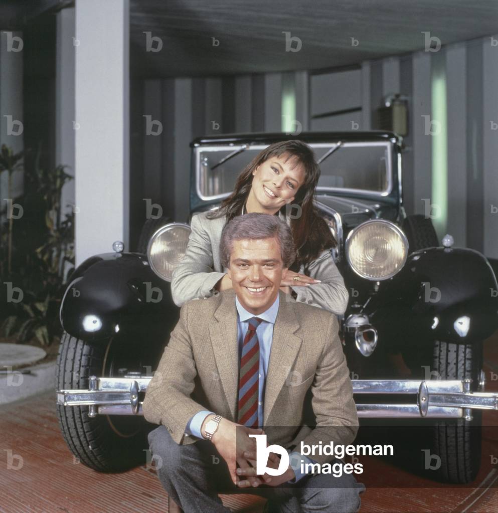 Cesare Cadeo and Paola Perego in front of a Cadillac, Italy