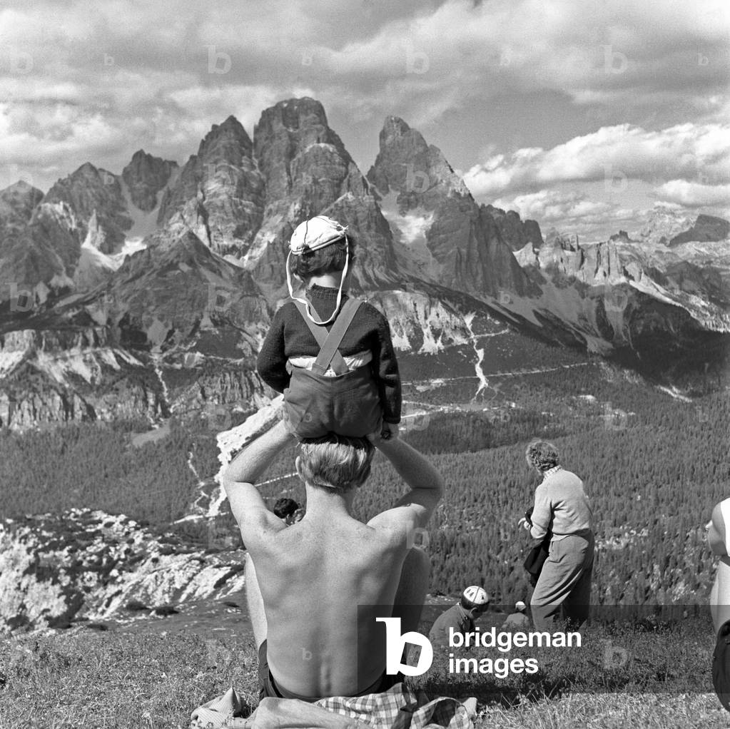 Tourists watching the Dolomites landscape , Cortina d'Ampezzo, Italy