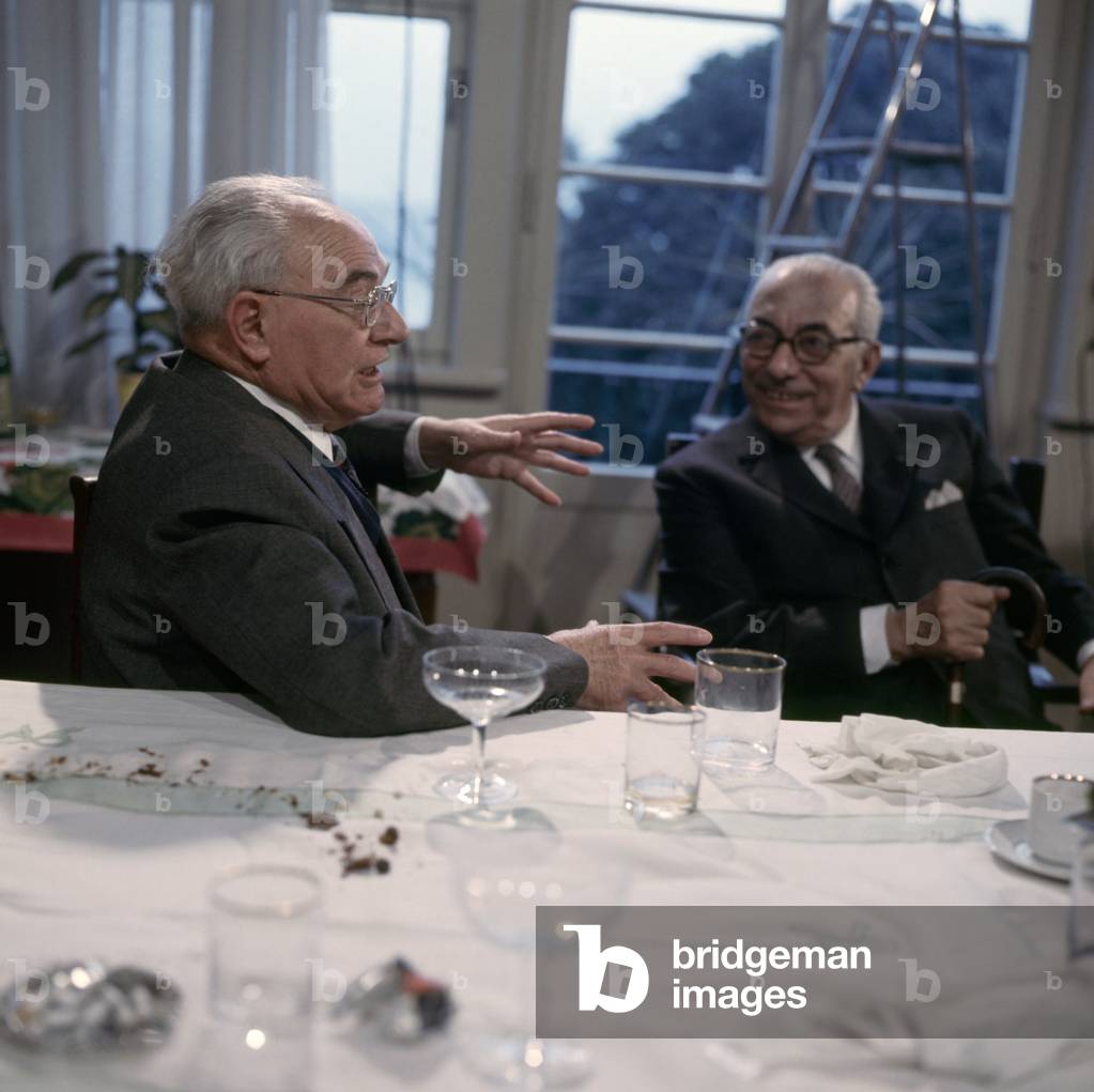 Italian publisher Arnoldo Mondadori talking with a man, Italy, 1960s (b/w photo)