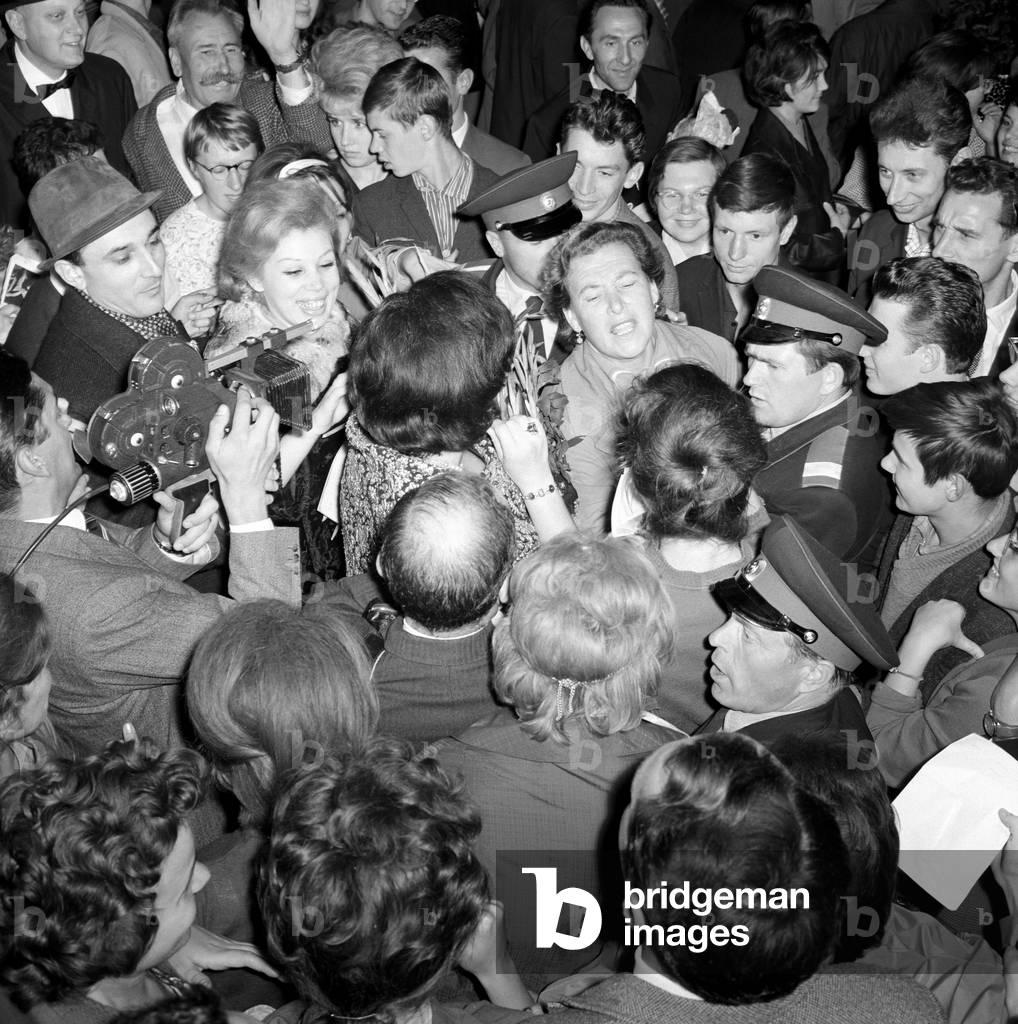 The actor of 'Turandot' surrounded by spectators outside the theatre, 1964 (b/w photo)