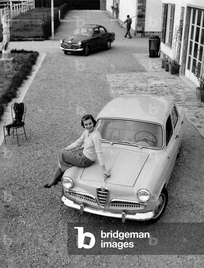 Anna Maria Ferrero sitting on the car bonnet of an Alfa Romeo Giulietta,  Milan, Italy