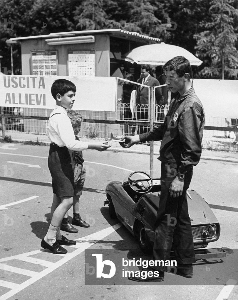 A boy and two children in a racetrack, Rome, Italy