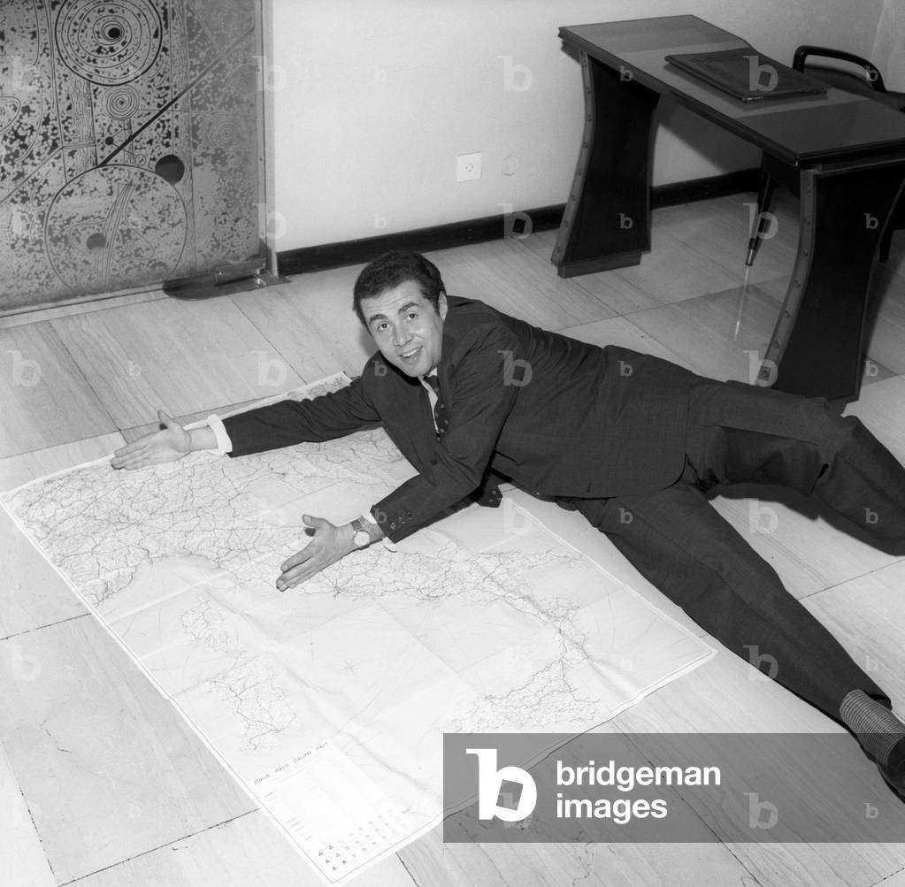 Enzo Tortora lying on the ground on a map of Italy,  Milan, Italy