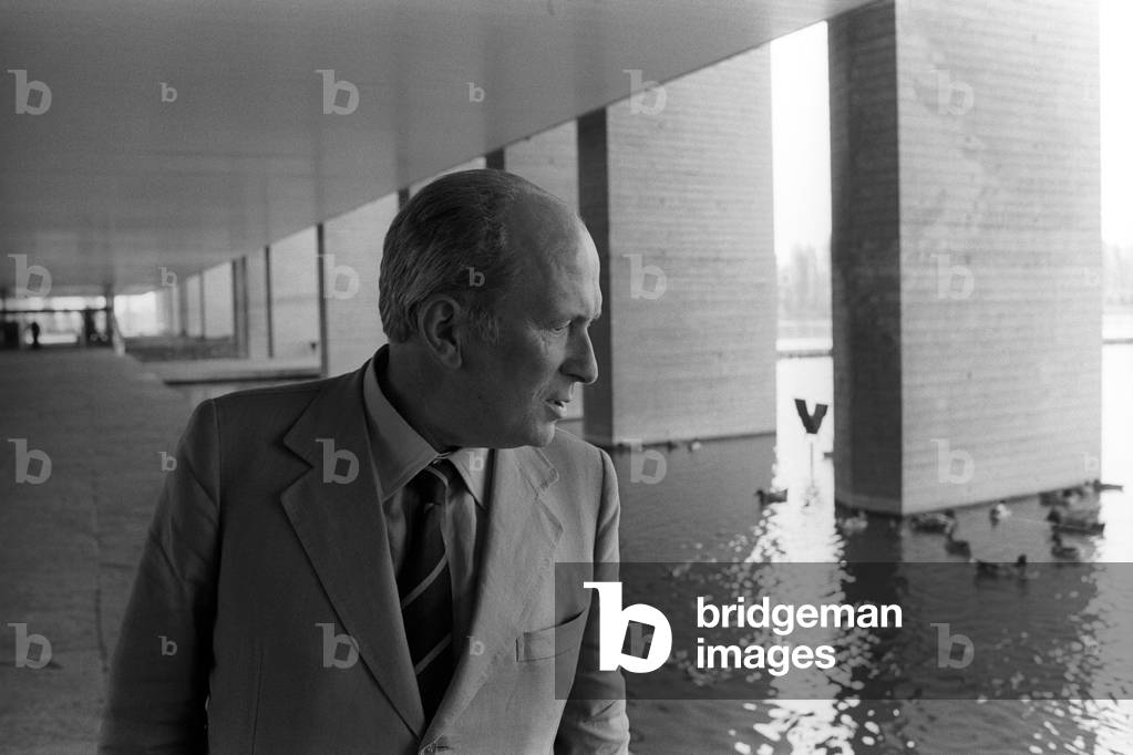 Oreste Del Buono looking at a small lake