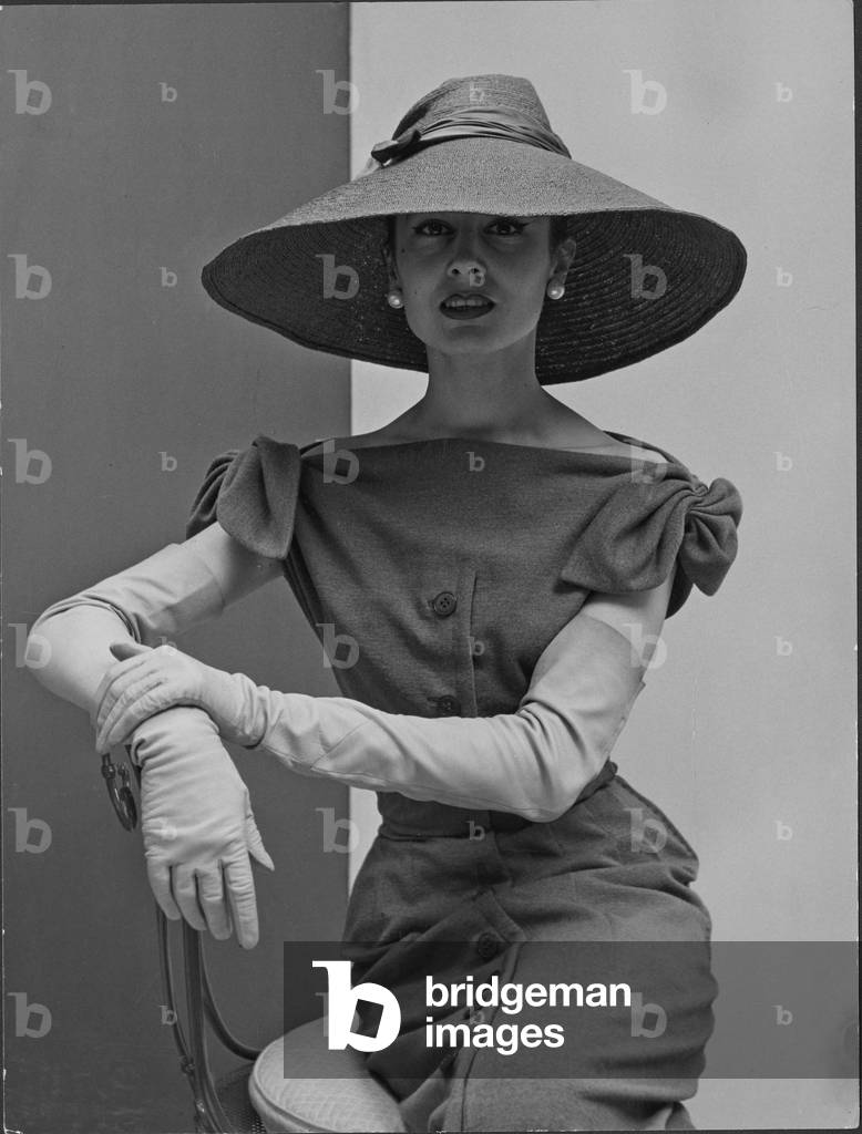 Dress with three quarter length gloves and a broad-brimmed hat