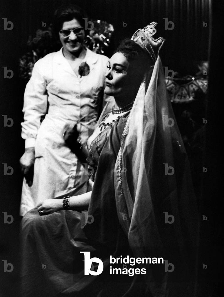 Joan Sutherland seated dressed in costume