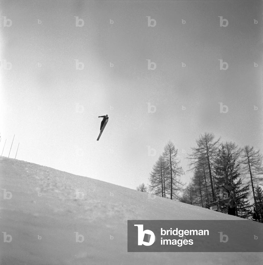 A skier performing a jump, Cortina d'Ampezzo, Italy, 1956 (b/w photo)