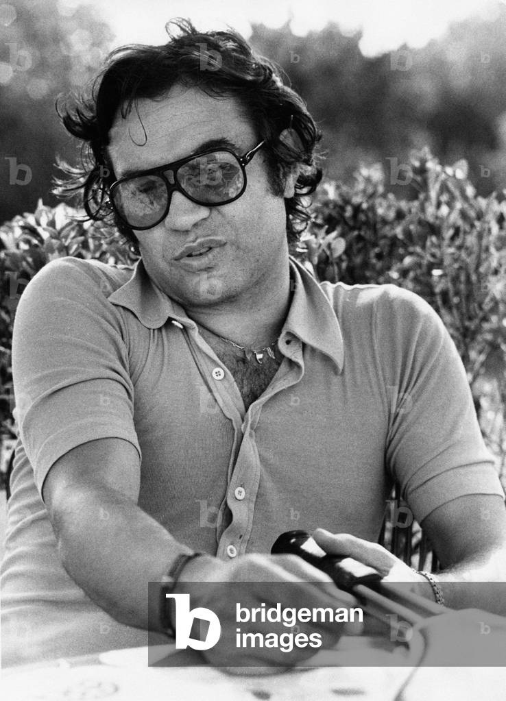 Fred Bongusto seated with a racket in his hands