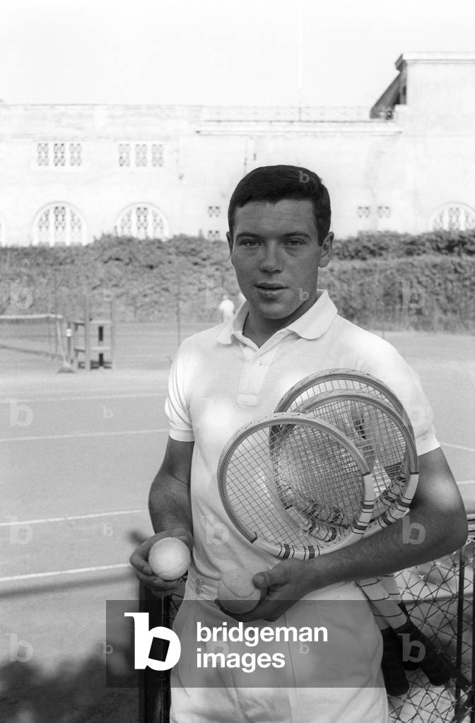 Nicola Pietrangeli in front of a court wearing sport clothes