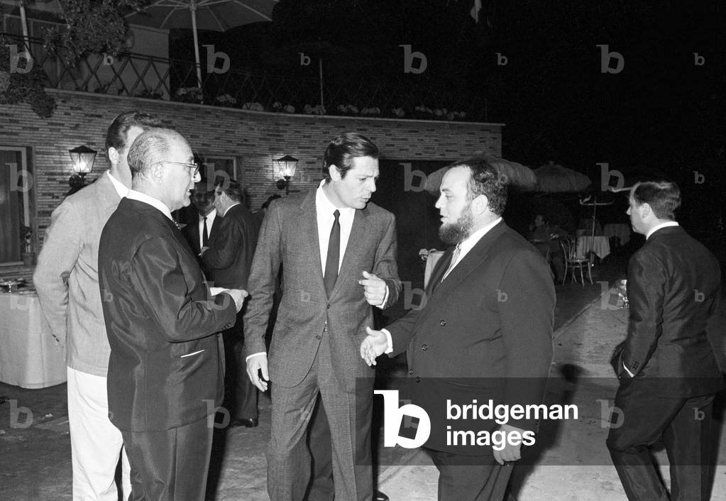 Marcello Mastroianni and Marco Ferreri at a cocktail party, Italy, 1964 (b/w photo)