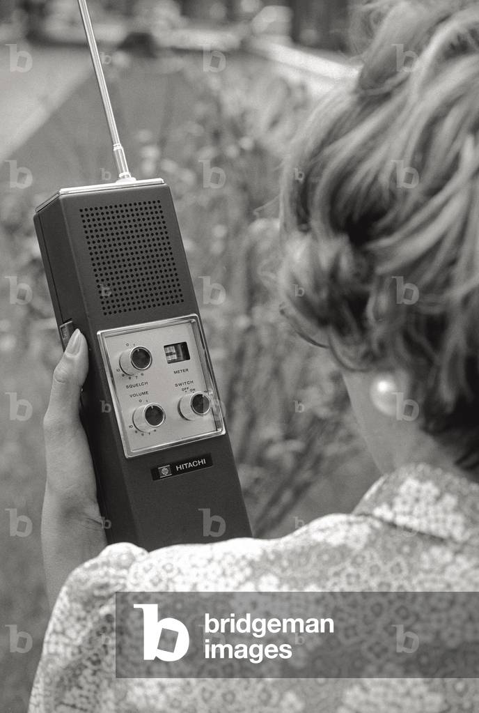 A woman using a walkie-talkie