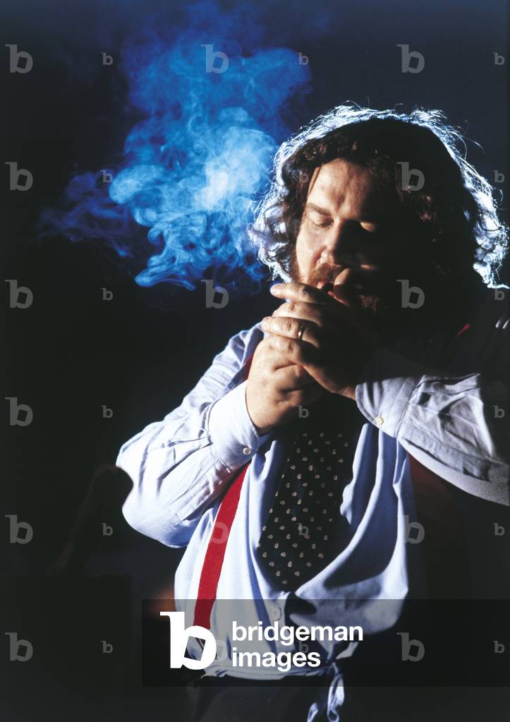 Giuliano Ferrara lighting a cigar